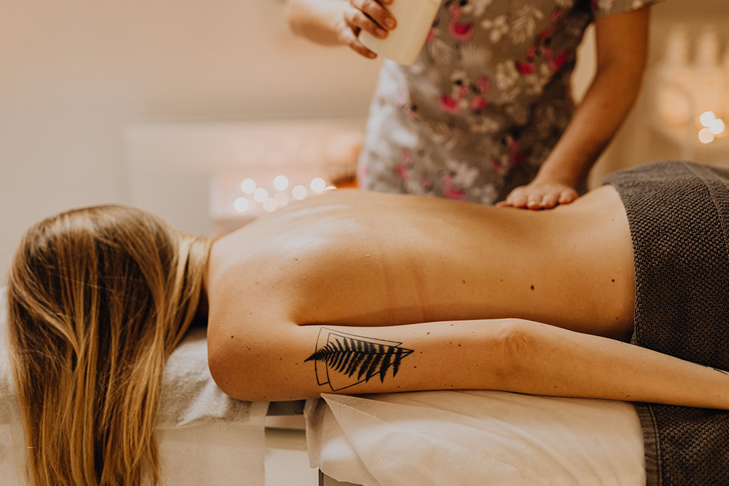 Warm organic oil massage for skin nourishment and muscle ease at Arowa Luxury Spa.